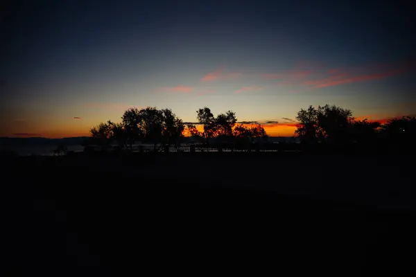 First Rays Sunrise Illuminate Sky Orange Show Silhouettes Mountains Trees — Stock Photo, Image