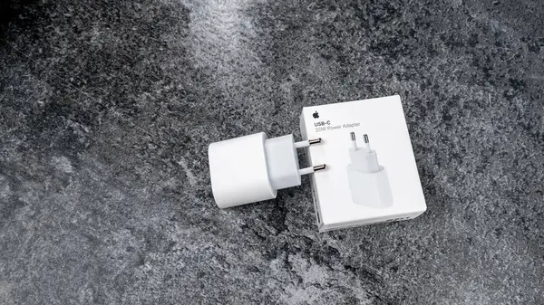 stock image Jurmala, Latvia 22.06.2024: White box from Apples original 20W charging adapter on grey table. High quality photo