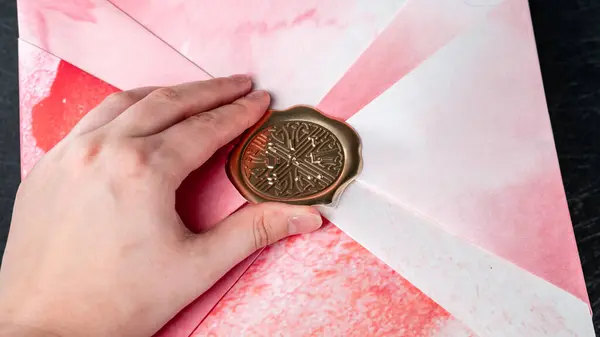 stock image Jurmala, Latvia 25.06.2024: A womans hand opens a pink set of body care cosmetics- Rituals The Ritual Of Sakura. . High quality photo