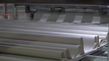 Automated cardboard factory. Corrugated cardboard moving on a conveyor belt. Cardboard box