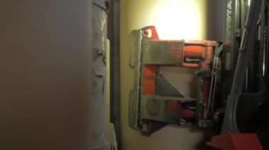 forklift puts a huge roll of paper in a warehouse to make paperboard from pulp