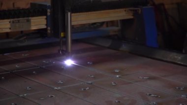laser cutting metal sheet into different shapes on production by industrial machine