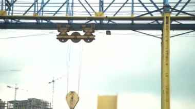 Gantry crane winches move on guides dragging heavy loads in production. Metallurgical heavy industry for the manufacture of steel, metal products