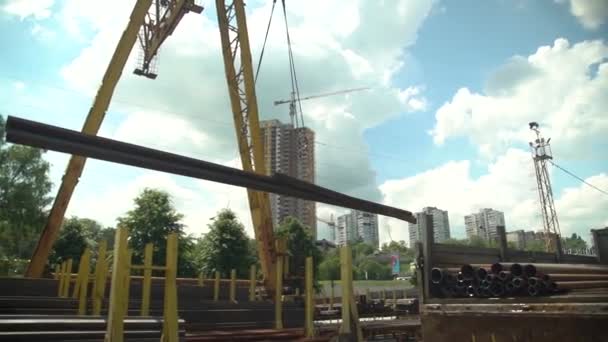Huge Gantry Crane Moves Large Metal Pipe Background City Blue — Stock video