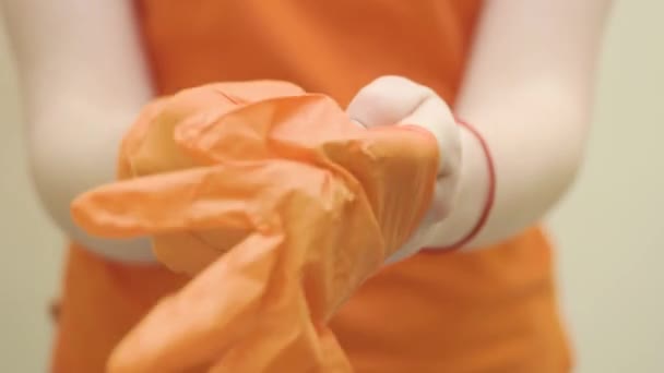 Cirurgião Dentista Coloca Luvas Rosa Estéreis Suas Mãos Enquanto Prepara — Vídeo de Stock