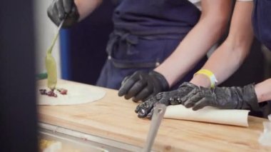 Povora cooks shawarma at a street food restaurant. Cooking doner kebab or fast food kebap