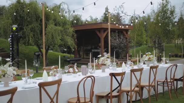 Svatební Stůl Pastelovými Divokými Květinami Svíčkami Staromódními Židlemi Retro Lampami — Stock video
