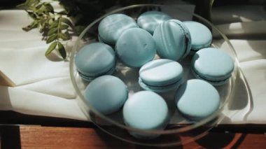 Candy bar blue colored macaroons cakes slow motion shot with soft natural light. High quality 4k footage