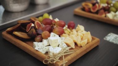 Cheese plate for wine with camembert, crostini, figs, grapes, honey and nuts. Wine set. High quality 4k footage