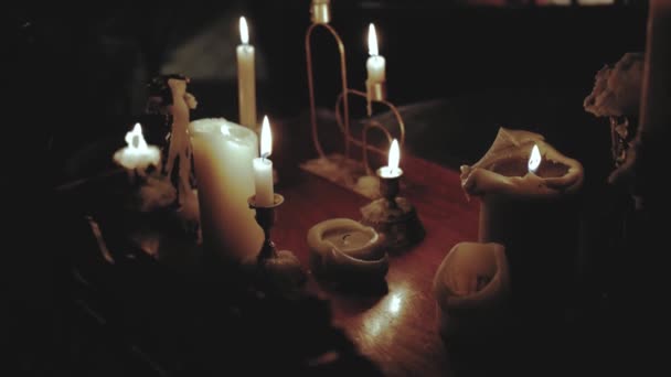 Close Veel Brandende Kaarsen Houten Tafel Donkere Kamer Alleen Aansteken — Stockvideo