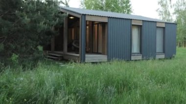 Çağdaş mimarinin yenilikçi bir örneği olan, verimli yeşillikte tasarlanmış, modern prefabrik bir ev.