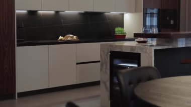 Bu şık mutfak zarif özellikler ve minimalist dekorlarla donatılmış modern bir tasarım sergiliyor.