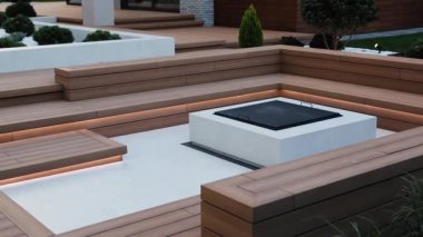 Açık verandada şömine ve uzun tahta bir bank. Evin yakınındaki piknik alanında. Büyük, dahili bir şömine. Serin sonbahar akşamları için sıcak bir yer. Yüksek kalite 4k görüntü