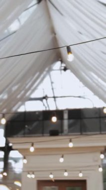 Light bulbs in the restaurant, bar beautiful decoration for the wedding, defocused shot, slow motion. High quality 4k footage