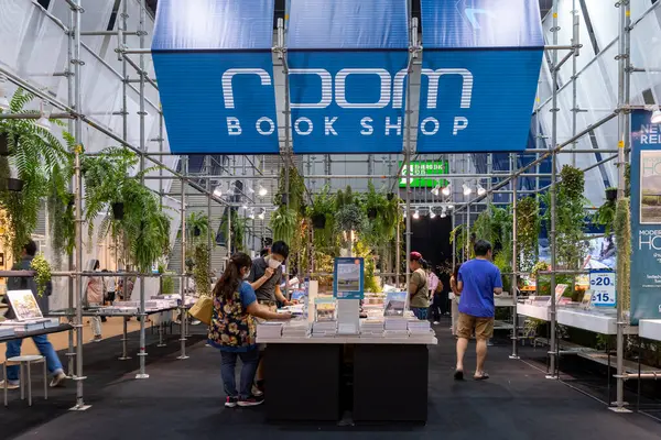 22 Mar 2025, Bangkok Tayland: Ziyaretçiler öğleden sonra bir etkinlik sırasında kalabalık bir kapalı markette canlı bir kitapçıyı keşfediyorlar