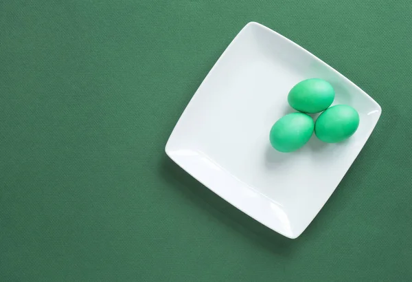 Green Eggs on White Plate on Green Background