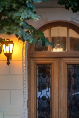 Glowing lantern on house wall
