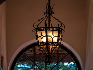 Glowing old lamp inside home