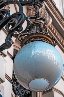 Big lantern on old building facade