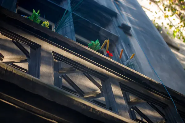 a building with a bunch of plants on the ledge
