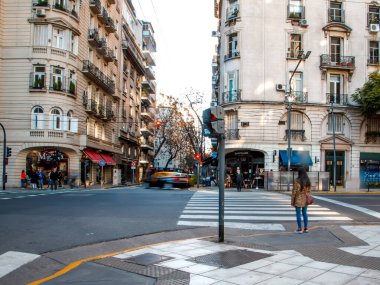 BUENOS AIRES, ARGENTINA - April 13, 2022: Street scene with architecture, transport and people 