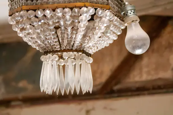 Chandelier with a light bulb hanging from it