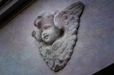 Dekoratif duvar cephesine monte edilmiş bir melek heykeli.