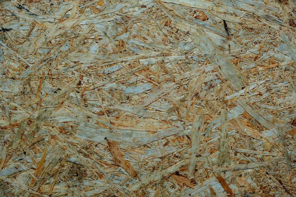Part of the decoration of the facade of the building and the material from which it is built; pressed board from wide pieces of wood shavings; oriented strand board