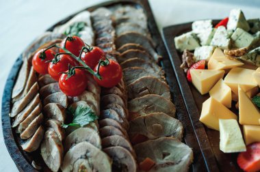 Dishes from the chef of the restaurant. A dish on a table in a cafe. Appetizing food from the restaurant menu. Fresh and tasty food. meatloaf and tomato and cheese plate for appetizers