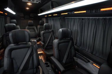 Comfortable interior of a passenger bus with soft seats. The design is made to order. Private covering of cars. Various elements of the bus interior.
