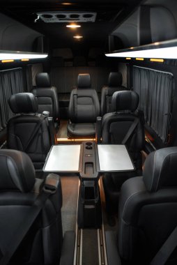 Comfortable interior of a passenger bus with soft seats. The design is made to order. Private covering of cars. Various elements of the bus interior.