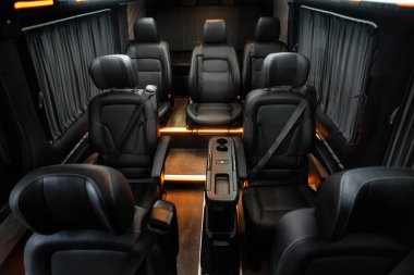 Comfortable interior of a passenger bus with soft seats. The design is made to order. Private covering of cars. Various elements of the bus interior.