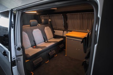 Comfortable interior of a passenger bus with soft seats. The design is made to order. Private covering of cars. Various elements of the bus interior.