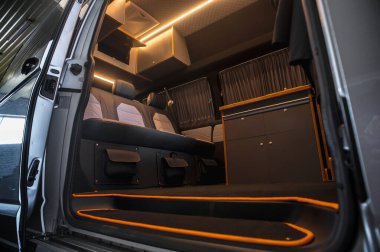 Comfortable interior of a passenger bus with soft seats. The design is made to order. Private covering of cars. Various elements of the bus interior.