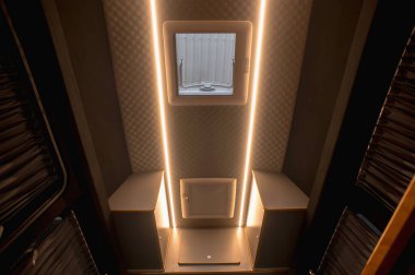 Comfortable interior of a passenger bus with soft seats. The design is made to order. Private covering of cars. Various elements of the bus interior.