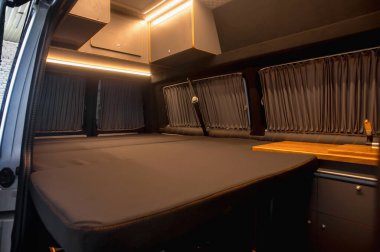 Comfortable interior of a passenger bus with soft seats. The design is made to order. Private covering of cars. Various elements of the bus interior.