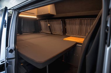 Comfortable interior of a passenger bus with soft seats. The design is made to order. Private covering of cars. Various elements of the bus interior.