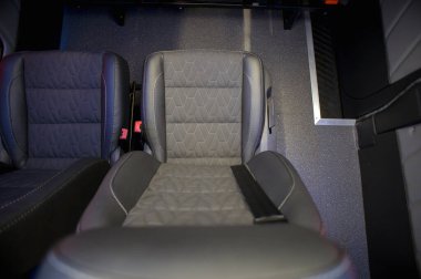 Comfortable interior of a passenger bus with soft seats. The design is made to order. Private covering of cars. Various elements of the bus interior.