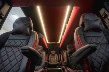 Comfortable interior of a passenger bus with soft seats. The design is made to order. Private covering of cars. Various elements of the bus interior.
