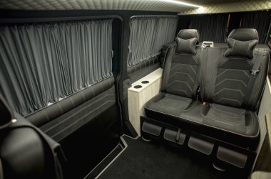 Comfortable interior of a passenger bus with soft seats. The design is made to order. Private covering of cars. Various elements of the bus interior.