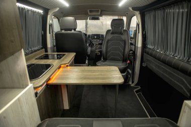 Comfortable interior of a passenger bus with soft seats. The design is made to order. Private covering of cars. Various elements of the bus interior.