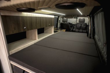 Comfortable interior of a passenger bus with soft seats. The design is made to order. Private covering of cars. Various elements of the bus interior.