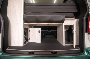 Comfortable interior of a passenger bus with soft seats. The design is made to order. Private covering of cars. Various elements of the bus interior.