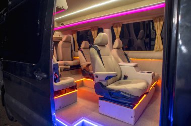 Comfortable interior of a passenger bus with soft seats. The design is made to order. Private covering of cars. Various elements of the bus interior.