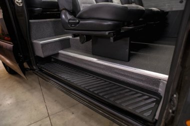 Comfortable interior of a passenger bus with soft seats. The design is made to order. Private covering of cars. Various elements of the bus interior.