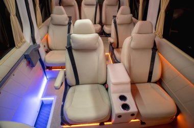 Comfortable interior of a passenger bus with soft seats. The design is made to order. Private covering of cars. Various elements of the bus interior.