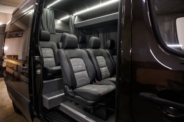 Comfortable interior of a passenger bus with soft seats. The design is made to order. Private covering of cars. Various elements of the bus interior.