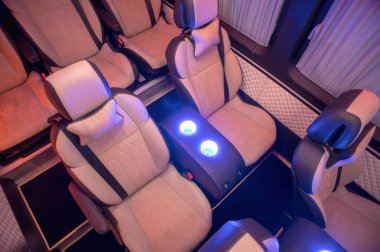 Comfortable interior of a passenger bus with soft seats. The design is made to order. Private covering of cars. Various elements of the bus interior.