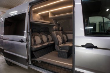 Comfortable interior of a passenger bus with soft seats. The design is made to order. Private covering of cars. Various elements of the bus interior.