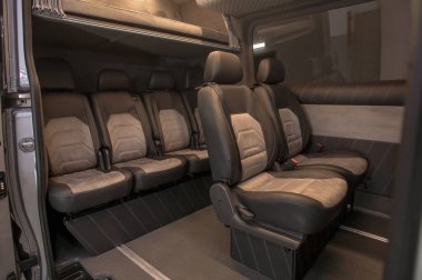 Comfortable interior of a passenger bus with soft seats. The design is made to order. Private covering of cars. Various elements of the bus interior.